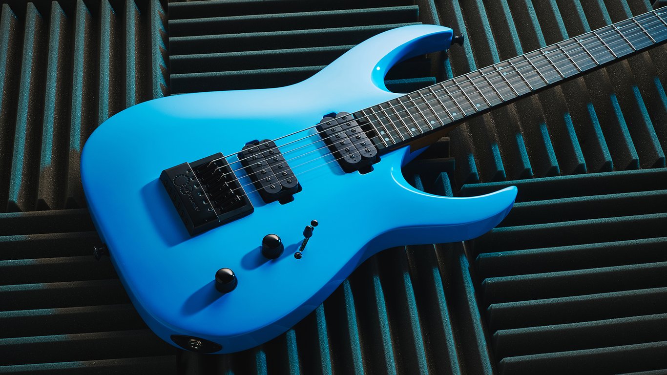 A Jackson Pro Plus Series Signature Misha Mansoor Juggernaut ET6 lying on some acoustic foam