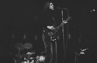 Jack Bruce (foreground), Ginger Baker (background), and Eric Clapton perform onstage in 1967