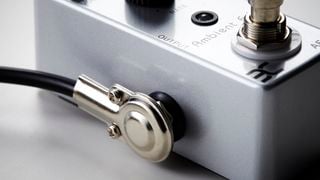 Pancake patch cable plugged into a pedal