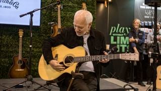 Peter Frampton admires a Martin guitar gifted to him by C.F. Martin & Co. during Global Media Day at The 2025 NAMM Show at Anaheim Convention Center on January 22, 2025 in Anaheim, California