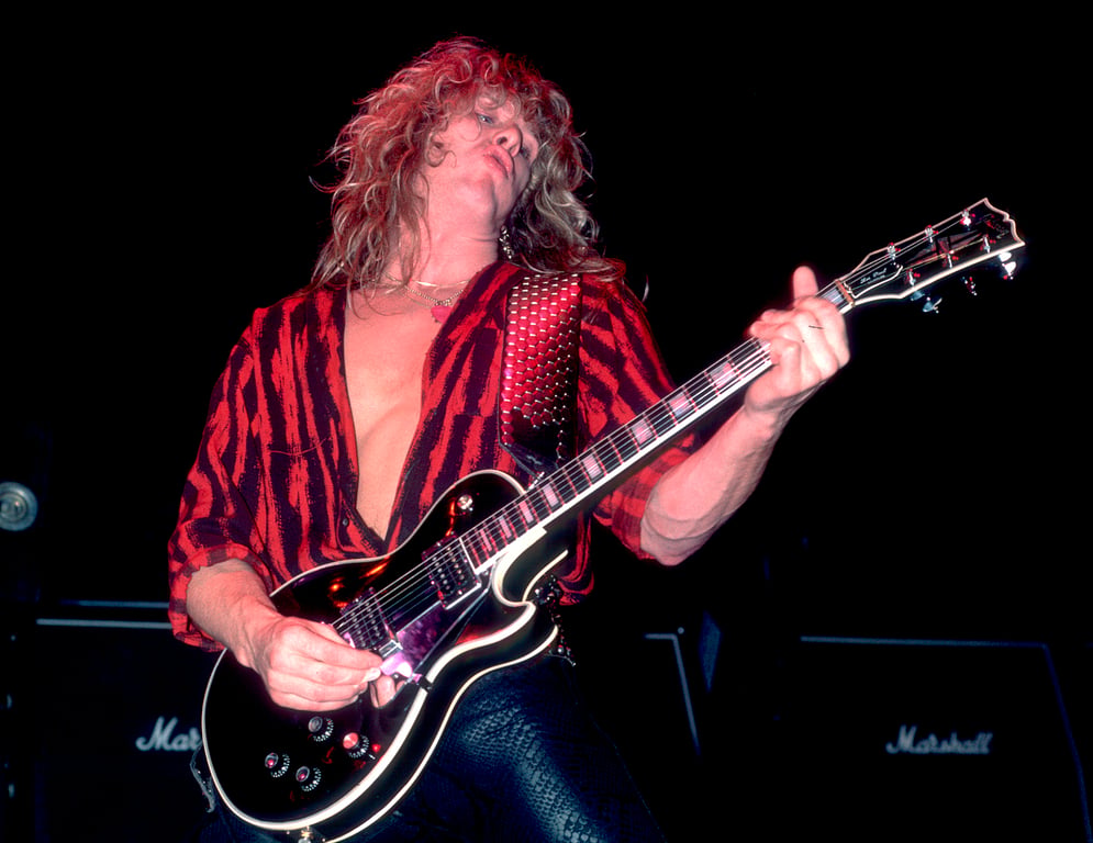 John Sykes performs onstage with Whitesnake at the Reunion Arena in Dallas, Texas on October 21, 1984