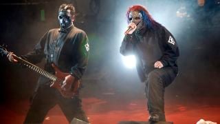 Photo of Paul GRAY and Corey TAYLOR and SLIPKNOT; Paul Gray (L) and Corey Taylor performing on stage