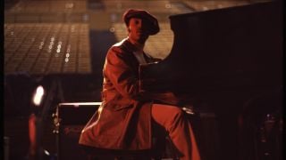 Musician Donny Hathaway sits at a piano on the stage of Royce Hall in UCLA with an empty audience during the rehearsal for Roberta Flack's Musical TV Special "Killing Me Softly" on September 11, 1972 in Los Angeles, Californi