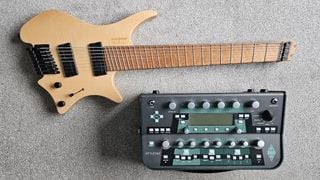 This writer's Strandberg guitar and Kemper Profiler on a beige carpet