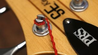 Winding strings on to a bass guitar tuning post