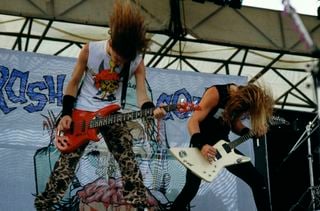 Jason Newsted (left) and James Hetfield perform onstage with Metallica at Castle Donington in Donington, England on August 22, 1987