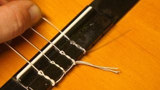Attaching treble strings to a classical guitar