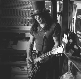 Slash holds one of his prized Gibson guitars