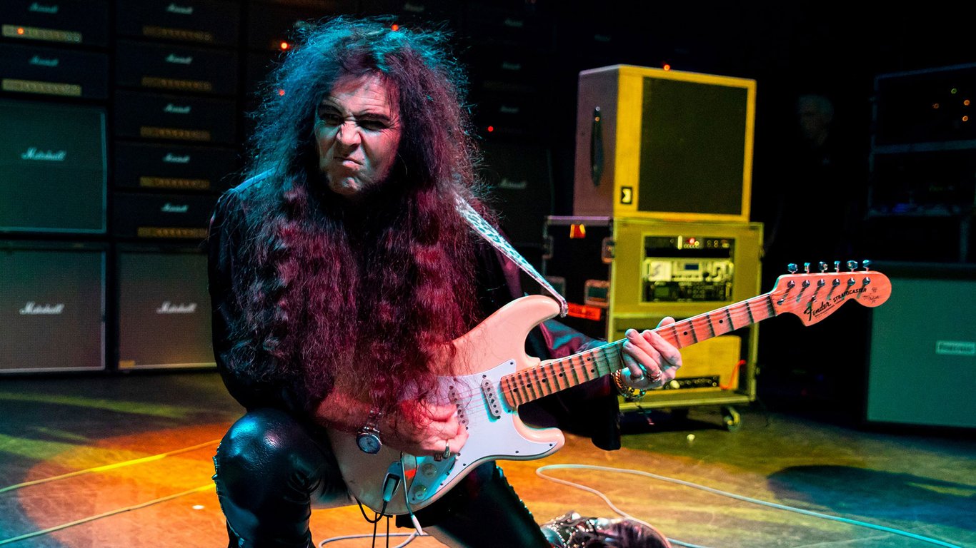 Yngwie Malmsteen holds a Strat with scalloped frets onstage at The Fillmore on November 21, 2018 in Detroit, Michigan