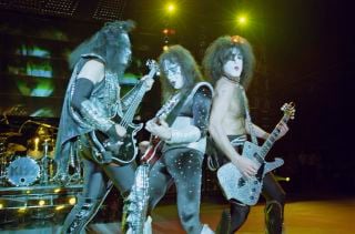 Ace Frehley (middle) performs onstage with Kiss