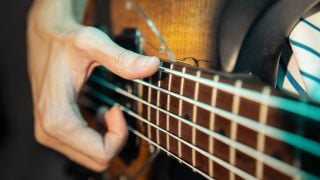 Bassist slapping electric bass guitar