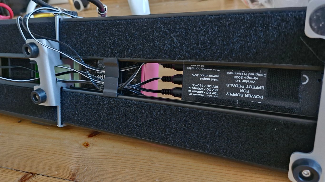 The underside of the Cioks Sol Future Power Generation power supply mounted to a pedalboard