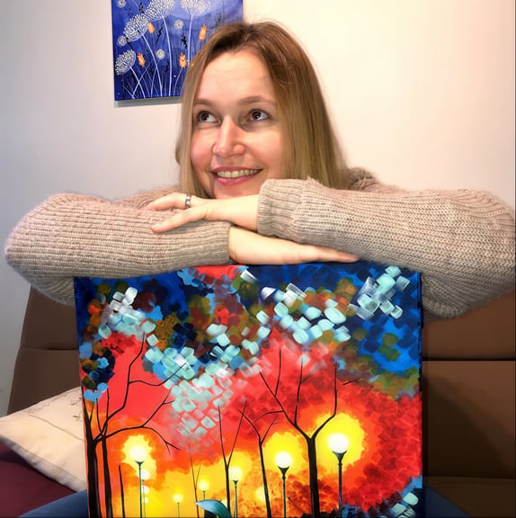 Aija Svarcs holding colourful painting