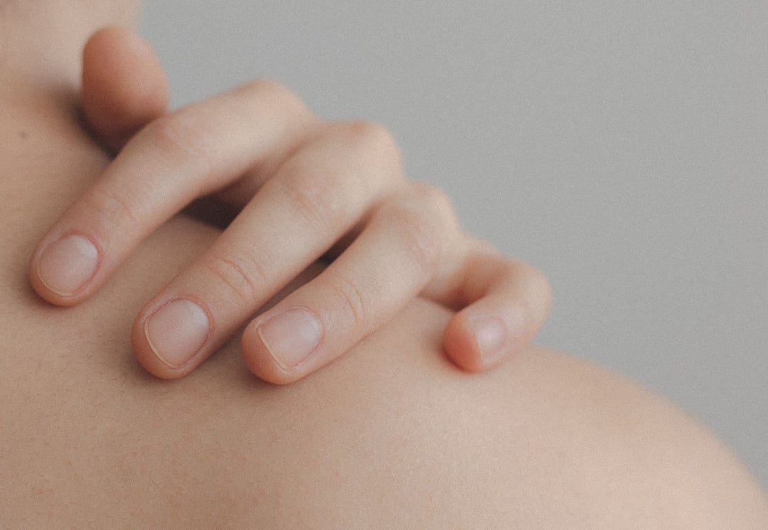 close up of hand resting on shoulder showing skin texture