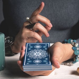 Manos sosteniendo un mazo de cartas azul