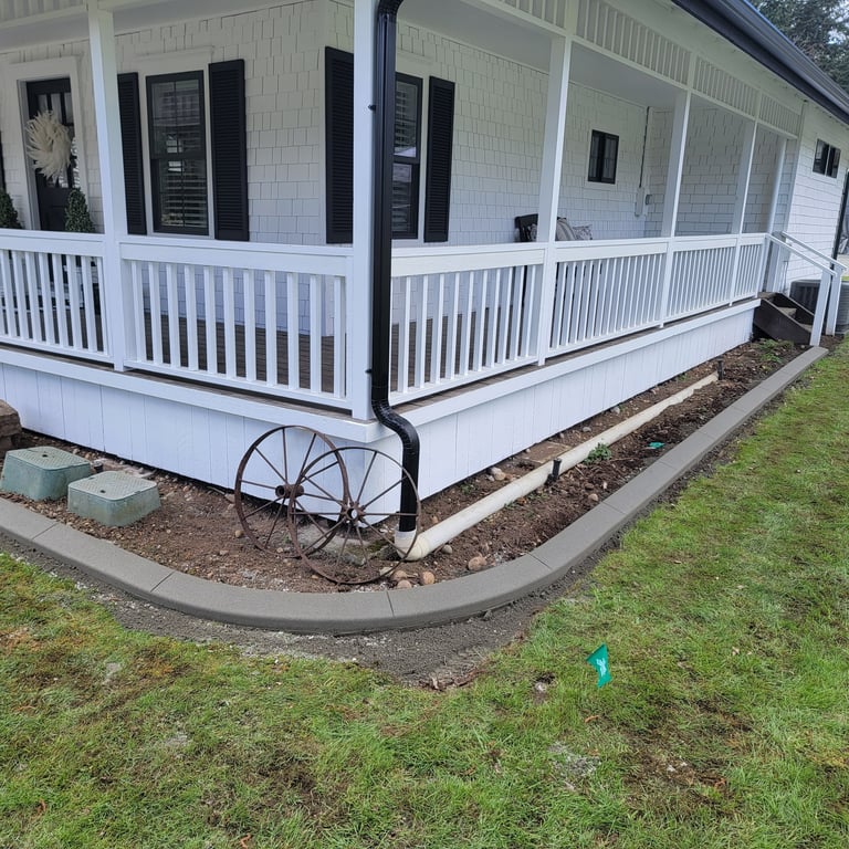Curbing in front of a house and some wheels