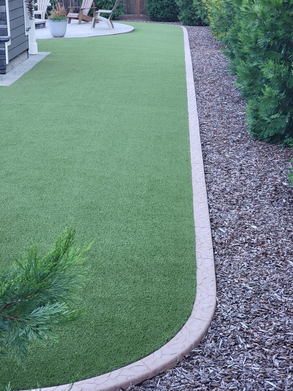 A tall photo showing a length of cobblestone curbing