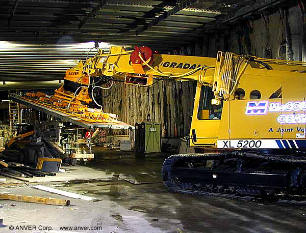 Gradall excavator vacuum end-effector placing panels in a tunnel