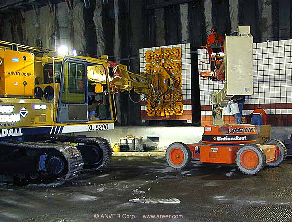 Gradall excavator vacuum end-effector placing panels in a tunnel