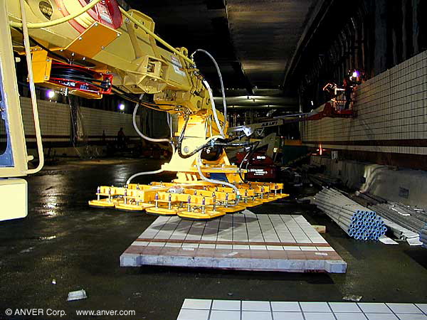 Gradall excavator vacuum end-effector placing panels in a tunnel