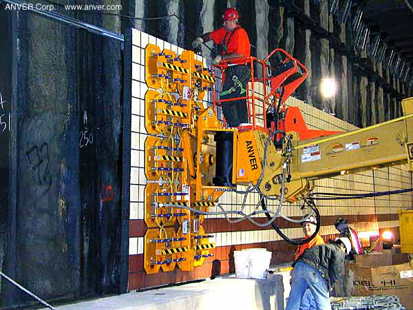 Gradall excavator vacuum end-effector placing panels in a tunnel