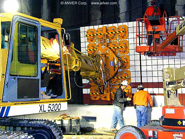 Gradall excavator vacuum end-effector placing panels in a tunnel