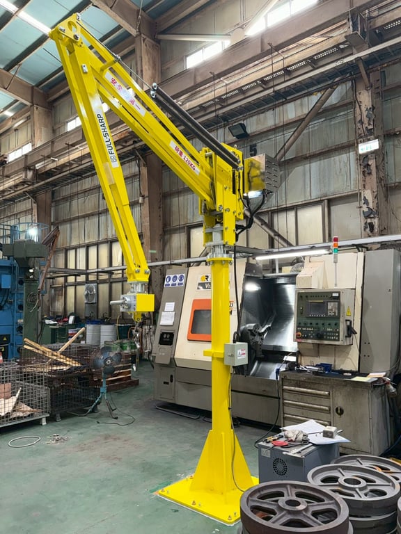 Electric lift arm serving a CNC machine