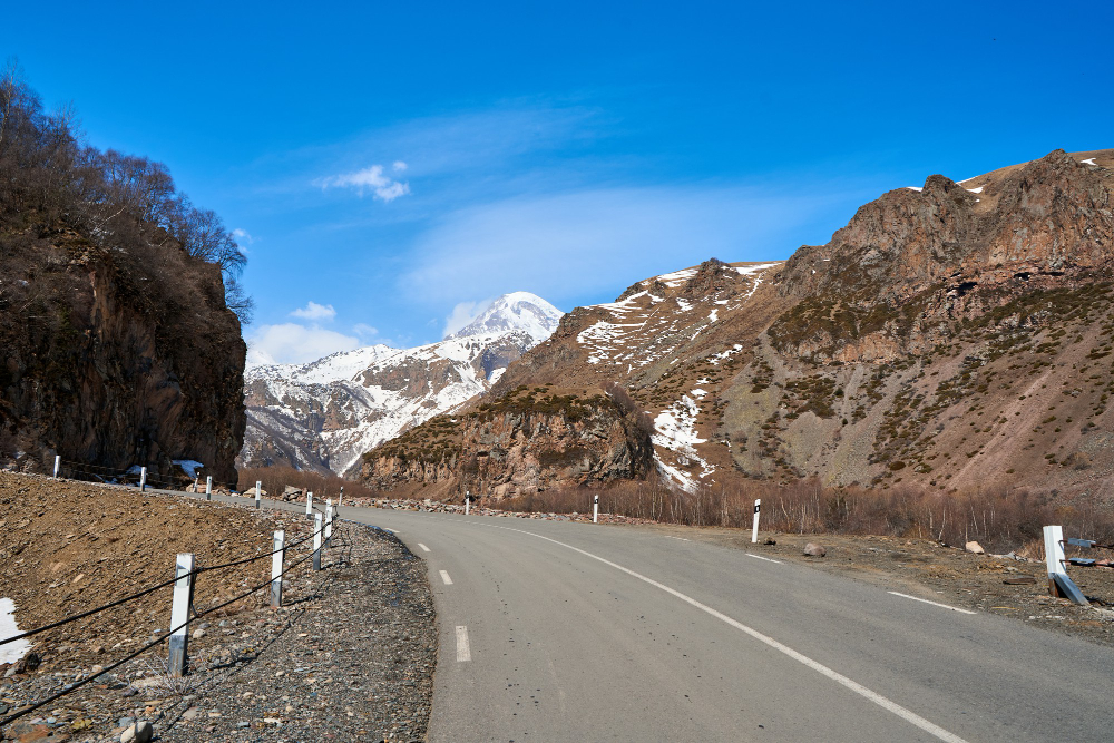 Ancient rock carvings along the Indus River near Chilas with Karakoram Highway visible, Diamer District, Pakistan