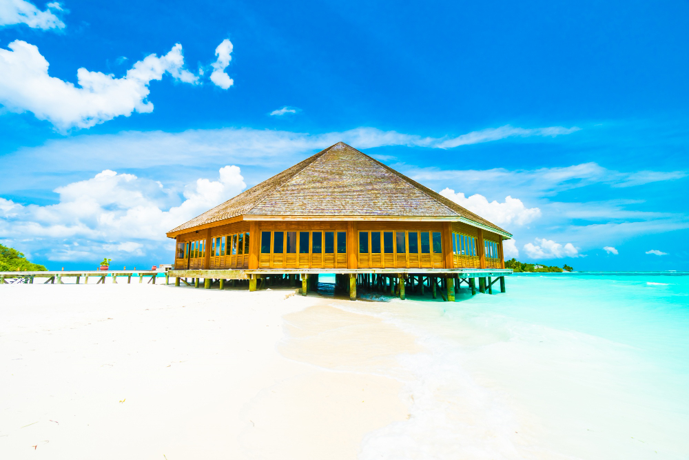 Crystal-clear lagoon and white sand beach at a luxury Maldives resort during dry season, North Male Atoll
