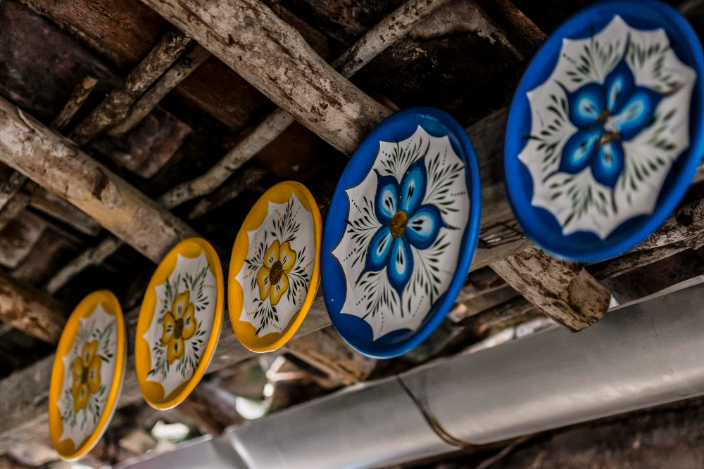 Amazigh artisan crafting traditional zellige tilework in a Fez medina workshop, Morocco