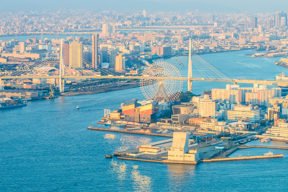 Aerial view of Baku skyline at dusk with the Flame Towers reflecting over the Caspian Sea, Azerbaijan