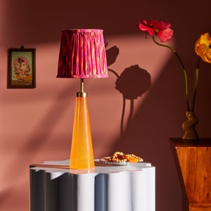 Cueva rechargeable table lamp in neon orange by Matthew Williamson