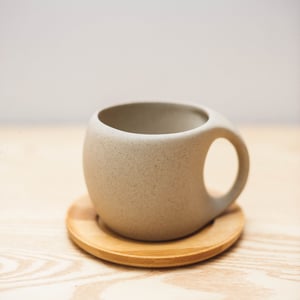 Ceramic teacup and wooden saucer