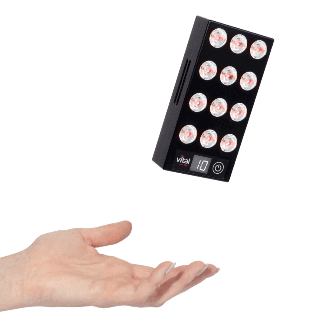 A sleek black rectangular device with circular lights, showcasing the number 10 and an illuminated power button, hovers above an open hand. This innovative gadget hints at potential red light therapy benefits for enhanced wellness.