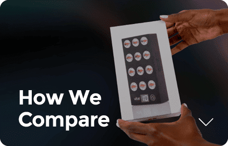 Hands holding a box featuring images of bottle caps with the text "How We Compare" in the corner, inviting curiosity akin to questions like, "What is red light therapy?.