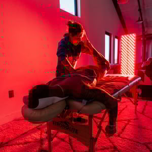 A man using massage with red light therapy to treat fibromyalgia