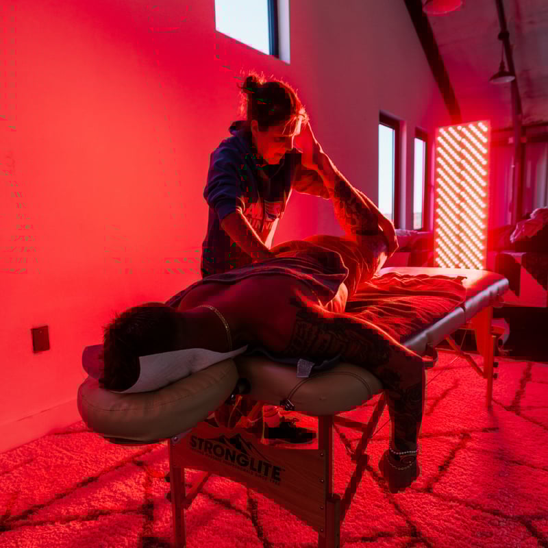 A man using massage with red light therapy to treat fibromyalgia