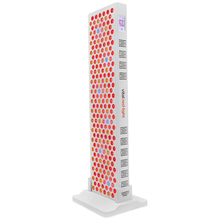 The tall, rectangular red light therapy machine, "Vital Elite 2.0," is mounted on a white base and showcases numerous circular red lights, providing full-body rejuvenation and wellness.