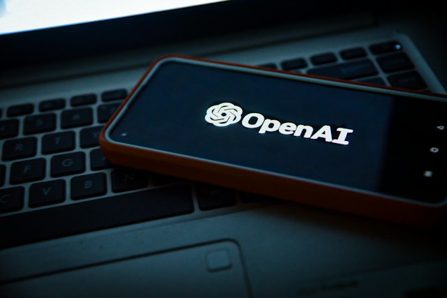 TechDogs-"An Image Of OpenAI's Logo On A Smartphone On A Laptop Keyboard"
