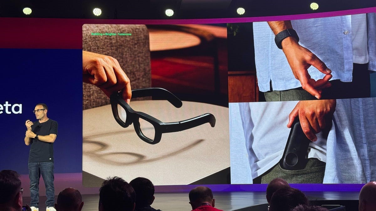 TechDogs-"What Was Said By Qualcomm’s SVP?"-"Meta VP Of Wearables And Automotive Alex Himel Speaks On Stage Presenting Wearable Glasses On Screen."