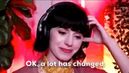 TechDogs-"Major Google Updates That Shaped Backlink Policy"-"A GIF Showing A Girl Wearing Headphones With A Text - OK, A Lot Has Changed"
