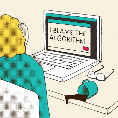 TechDogs-"What Is Answer Engine Optimization (AEO)?"-"A Gif Showing A Cartoon Of A Person Sitting In Front Of A Computer With A Text On It - “I Blame The Algorithm”"