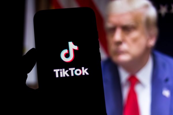 TechDogs-"An Image Showing Donald Trump And A Phone With TikTok Logo On The Screen"