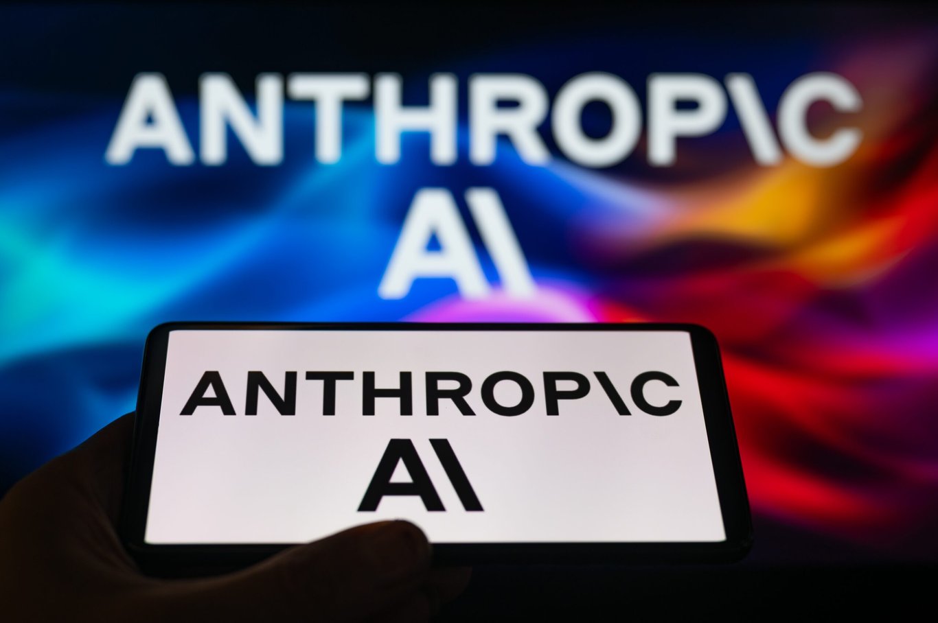 TechDogs-"An Image Of Anthropic's Logo In The Background And On A Phone"