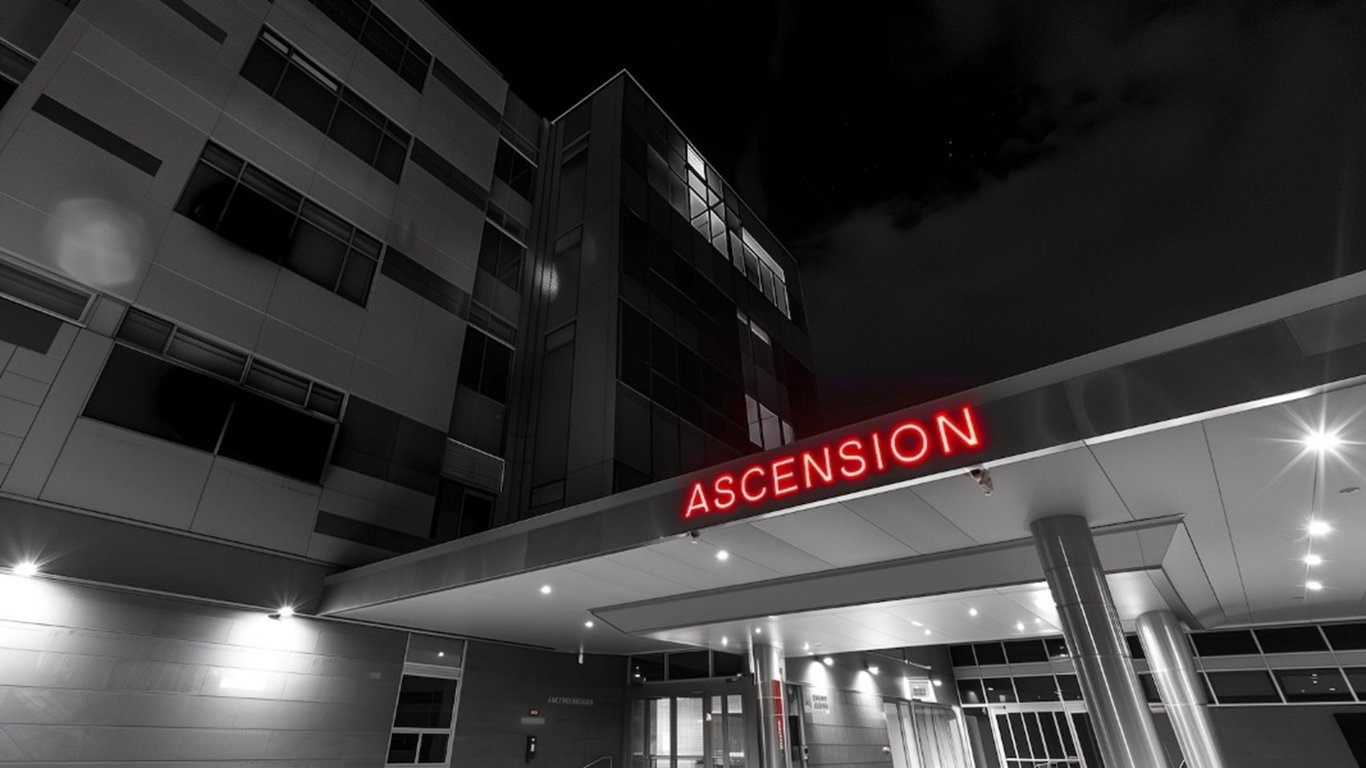 TechDogs-"What Happened At Ascension?"-"Modern Ascension Healthcare Facility Illuminated At Night Showcasing Sleek Architecture And Bright Neon Red Sign"