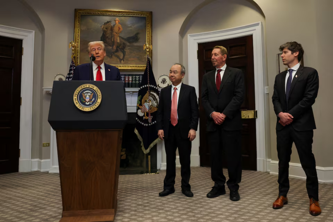 TechDogs-"An Image Of U.S. President Donald Trump With SoftBank CEO Masayoshi Son, Oracle Co-Founder Larry Ellison, and OpenAI CEO Sam Altman At The Announcement"