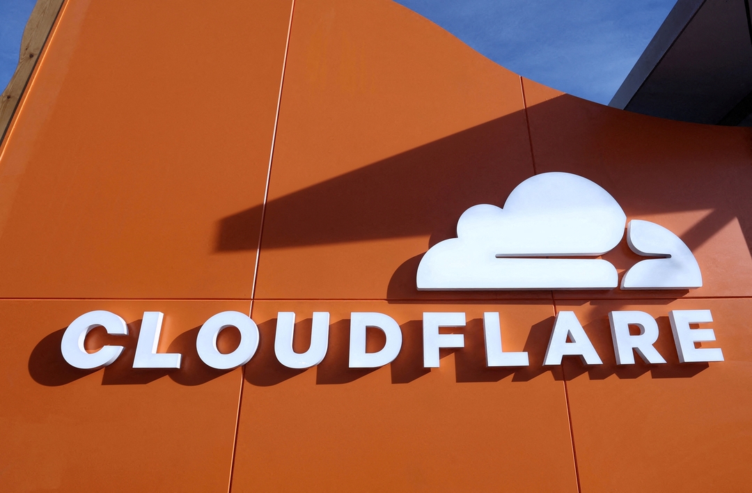 TechDogs-"Cloudflare Logo on Orange Wall Signifying AI Bot Monetization Tool Launch"