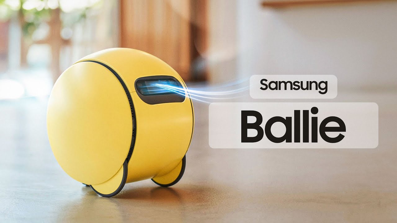 TechDogs-"What Is Samsung's AI 'Ballie'?"-"Samsung Ballie Smart Home Robot In Yellow Rolling Indoors With Logo"