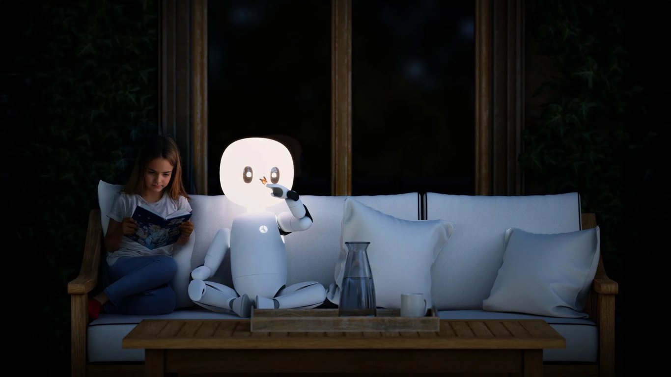 TechDogs-"An Image Showing A Girl Sitting With A Humanoid Robot"
