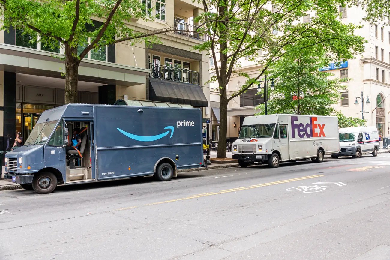 TechDogs-"Amazon, FedEx, And USPS Trucks Parked Together Amid New Delivery Deal"